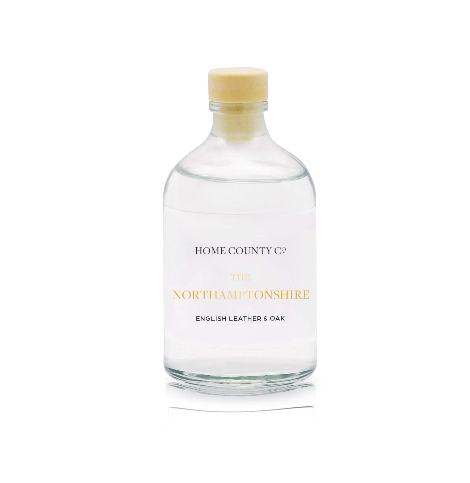 A English leather and oak reed diffuser refill is shown in a recyclable glass bottle