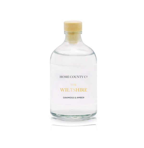 An oakmoss and amber rose reed diffuser refill is shown in a recyclable glass bottle