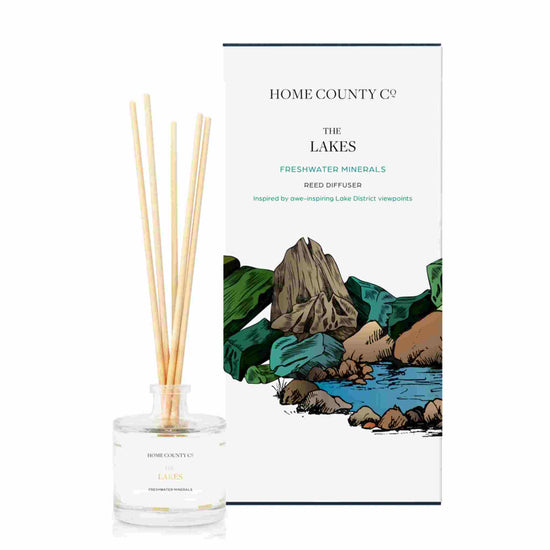 A freshwater minerals scented reed diffuser from Home County Co. The vegan friendly reed diffuser is shown next to the eco friendly reed diffuser box packaging.