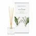 A lily of the valley scented reed diffuser from Home County Co. The vegan friendly reed diffuser is shown next to the eco friendly reed diffuser box packaging.