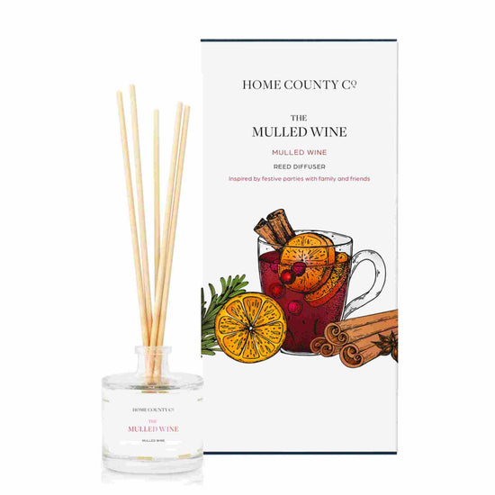 A mulled wine scented reed diffuser from Home County Co. The vegan friendly reed diffuser is shown next to the eco friendly reed diffuser box packaging.