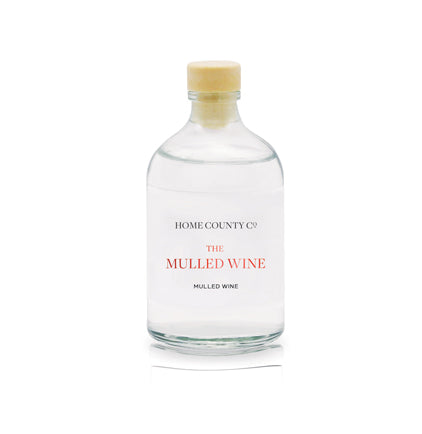A mulled wine scented reed diffuser refill from Home County Co. The eco friendly reed diffuser refill is shown in its recyclable glass bottle.