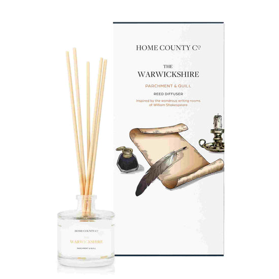 A parchment and quill scented reed diffuser from Home County Co. The vegan friendly reed diffuser is shown next to the eco friendly reed diffuser box packaging.
