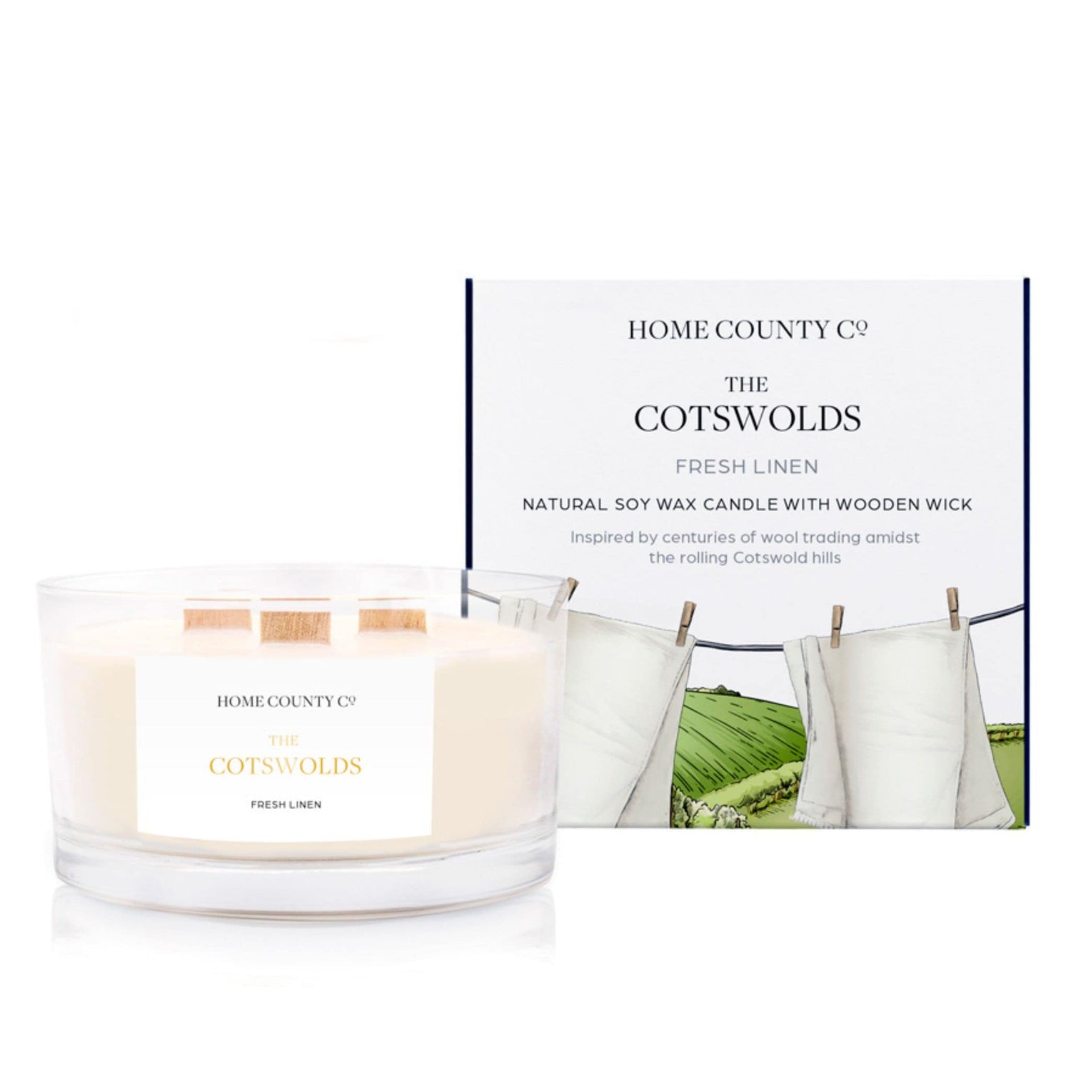 A fresh linen scented 3 wick candle from the Home County Co. is shown next to its eco-friendly candle packaging box. 