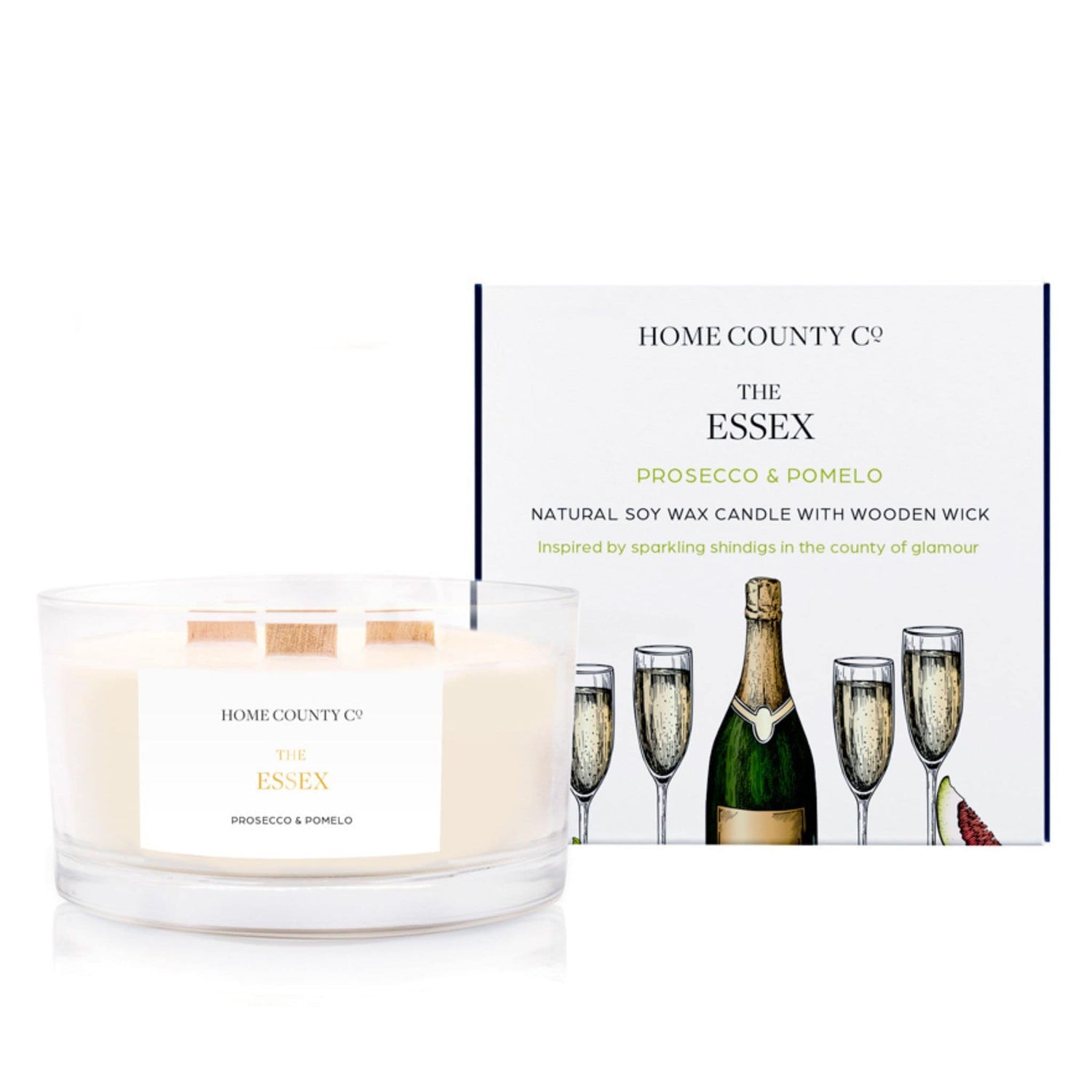 A Prosecco and pomelo scented 3 wick candle from the Home County Co. is shown next to its eco-friendly candle packaging box. 