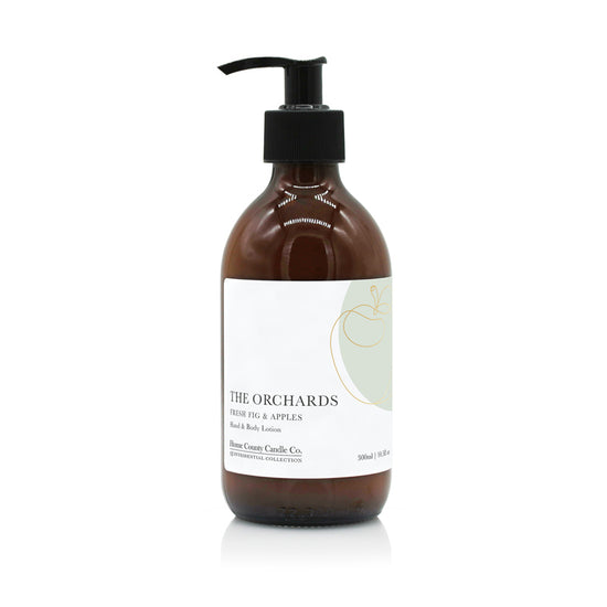 A 300ml fresh fig and apples scented hand and body lotion from the Home County Co. is shown in its eco-friendly amber glass bottle