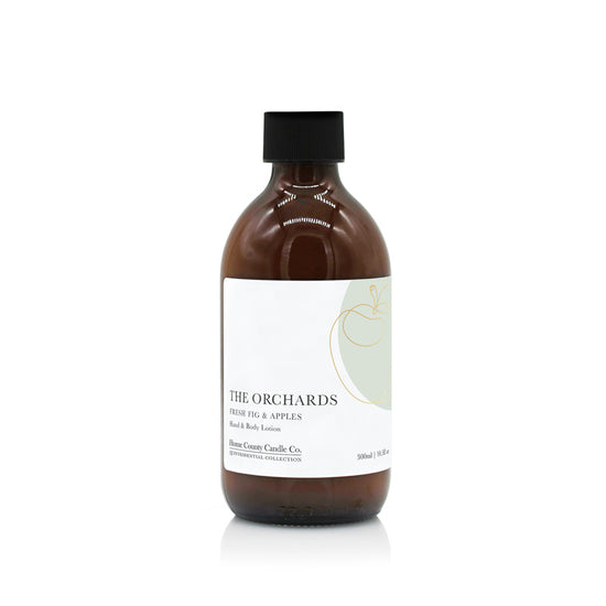 A 300ml fresh fig and apples scented hand and body lotion from the Home County Co. is shown in its eco-friendly amber glass bottle