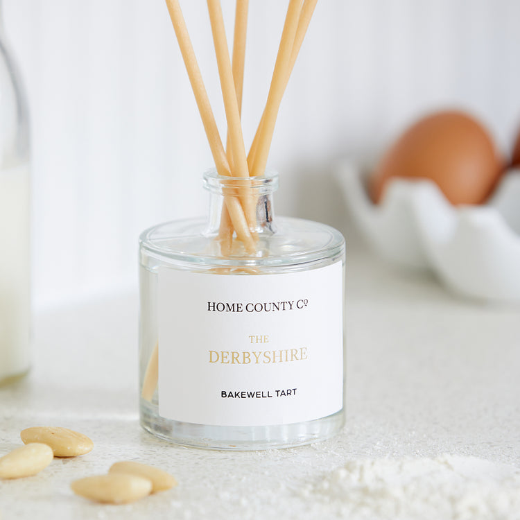 A Derbyshire Bakewell Tart reed diffuser is shown on a kitchen worktop