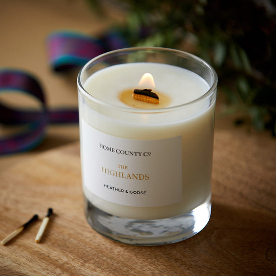 A Scottish Highlands candle from the Home County Co is shown alight