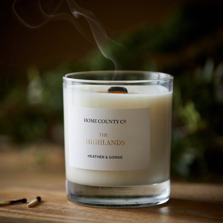 A Scottish Highlands candle from the Home County Co is shown with the candle blown out