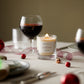 A Mulled Wine scented candle from the Home County Co. is shown alight on a Christmas table 