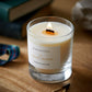 An Orkney Islands seaweed and samphire scented candle from the Home County Co is shown with its wooden wick alight